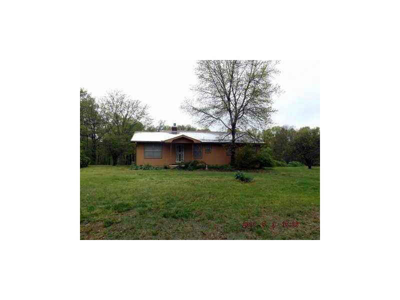 On the HWY yet secluded, 14 wooded acres with a good house and outbuilding. Wood stove insert and large bedrooms.