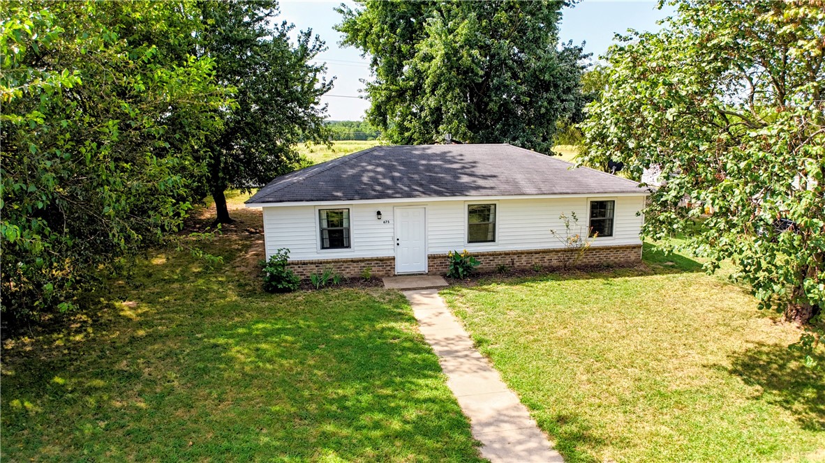 Updated and move-in ready! This adorable 960sf home has 3 bedrooms & an updated bath! The eat-in kitchen features newer appliances - dishwasher 2021, electric glass-top stove & vent hood 2024, & garbage disposal in 2021. Interior repainted. Doors added to the utility room. Updated lighting and flooring(in bdrms) in 2024/2025. Bathroom updates include vanity, faucet, shower head, & lighting 2024. HVAC was replaced in 2025, the roof was replaced in 2020, and a storage building was added in 2025. Both front & rear exterior doors replaced in 2021. Easy to maintain vinyl siding & brick exterior. Natural gas service on the lot, but the house is all electric currently. Wire fencing on 3 sides in the backyard with mature trees.