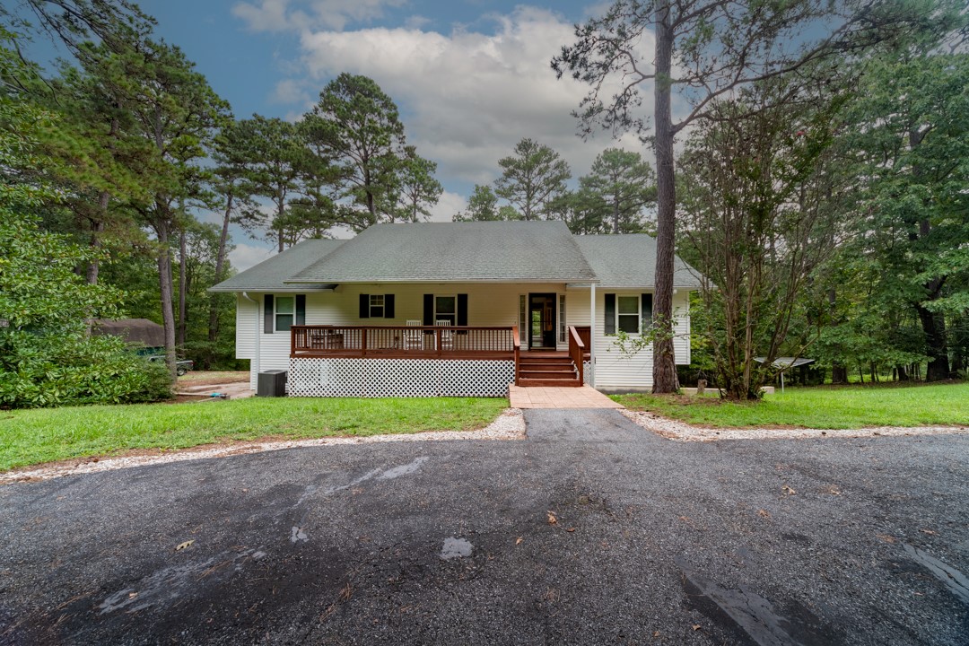 Country style home sitting on 5 acres w/3 bedrooms & 3 baths. This is a tranquil get away, with all the benefits of being close to all the hustle and bustle of NWA. From the circular driveway, the charming elegance of a front porch w/room for rockers or a porch swing greets each guest. Step inside to a view unobstructed straight out onto the back deck that is a nature lovers paradise. The main floor of the home features a semi-open kitchen situated to give open access to a dining area & living room #1, as well as beautiful views of nature. Down the hall you will find the owners suite w/a private balcony, 2 bedrooms & guest bath. In the walk out basement you will find 2 living areas, a space that is currently being used as an office, lots of storage & an additional bathroom w/shower. The basement has its own private entrance as well as access to the garage. Perfect for an office, MIL suite or AB&B. There is a 20X10 outbuilding with electricity for a shop. This property has so many possibilities! Come see today