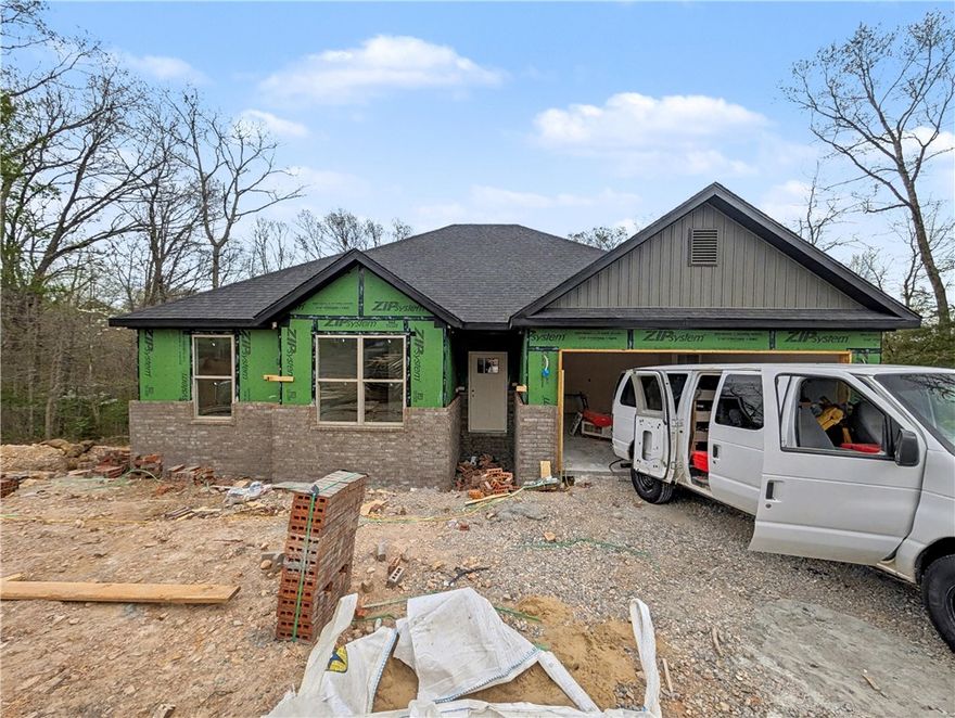 Welcome To Your Next Home! Picture It — A Fresh New Build With A Classic Brick Front, A Smart Split Floorplan, And 9-Foot Ceilings That Make Every Space Feel Bright And Open. The Living Room Steals The Show With A Vaulted Ceiling, Beams For That Extra Drama, Flowing Seamlessly Into A Kitchen That’s As Functional As It Is Stunning — Upgraded Cabinets To The Ceiling, Quartz Counters, Tile Backsplash, Island With Bar Seating, Pantry, And A Spacious Dining Area. The Primary Suite Offers A Dual Vanity, Full Custom Tile Shower, And A Walk-In Closet That Cleverly Passes Through To The Laundry/Utility Room For The Ultimate Convenience. Thoughtful Storage Is Tucked Throughout, And Out Back You’ll Find A Covered Deck Overlooking A Future Freshly Sodded Yard And Peaceful Views. Branchwood Rec Center And Nature Trail Close By. Pick Your Interior Finishes. Finished Pics As Example Of Previous Build. **Deeded As 2 Bed Septic, 3rd Room To Be Considered Office/Bonus Other Non-sleeping Room. Signed acknowledgment required.