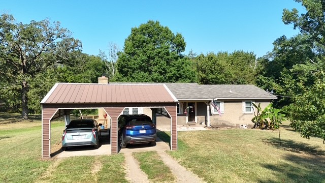 Charming 4-Bed, 2-Bath Brick Home on 2 Acres+/- Large Shop and Creek! Welcome to this beautifully maintained 1,713 sq ft brick home on 2 scenic acres. Featuring 4 bedrooms & 2 full baths in a desirable split floor plan, this home offers both comfort and functionality. Step inside to find a cozy wood-burning fireplace in the living area, bright eat-in kitchen w/ pantry, and large utility room for added convenience. The primary suite is separated for privacy, complete w/ bathroom and walk-in closet. Enjoy peace of mind with recent upgrades including a brand-new roof (2025) and new HVAC system (2023). Outdoor living is a dream here with a covered front porch, new rear deck perfect for gatherings, and mature shade trees. A wet weather creek adds natural charm to the landscape. Need workspace or storage? You'll love the 28'x46' insulated shop with 12-foot overhead door, ideal for hobbies, equipment, or your toys. Donāt miss this rare opportunity for country living with modern amenitiesāschedule your showing today!