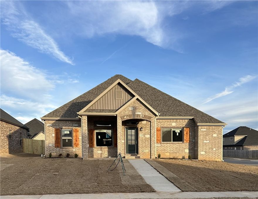 Stunning new construction—this single-story home on a corner lot features 3 bedrooms, 2.5 bathrooms, and a spacious 3-car garage. The kitchen is equipped with stainless steel appliances, a gas range, microwave vent hood, pantry, and granite countertops. A large fireplace with shiplap detail is flanked with built-in bookshelves serves as a striking centerpiece in the living room. Elegant details include wood-cased windows with 2-inch blinds throughout. Enjoy great curb appeal with a large front porch, fully sodded oversized yard, and a privacy fence. The covered back porch and fully installed gutters add both comfort and functionality. A keyless garage door pad offers convenient access. The primary suite boasts an oversized tiled shower and a walk-in closet that connects directly to the laundry room, located near the garage for added convenience. Durable brick exterior construction ensures longevity and low maintenance. Mailing address is Bentonville, home located inside Centerton city limits
