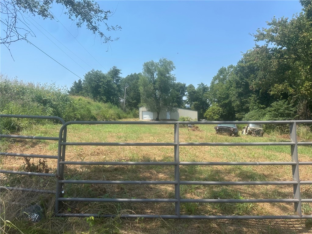 1800 sq. ft. commercial warehouse on 1.63 acres at the edge of Green Forest. Cement floor and ready to develop with end of the road privacy and all fenced.