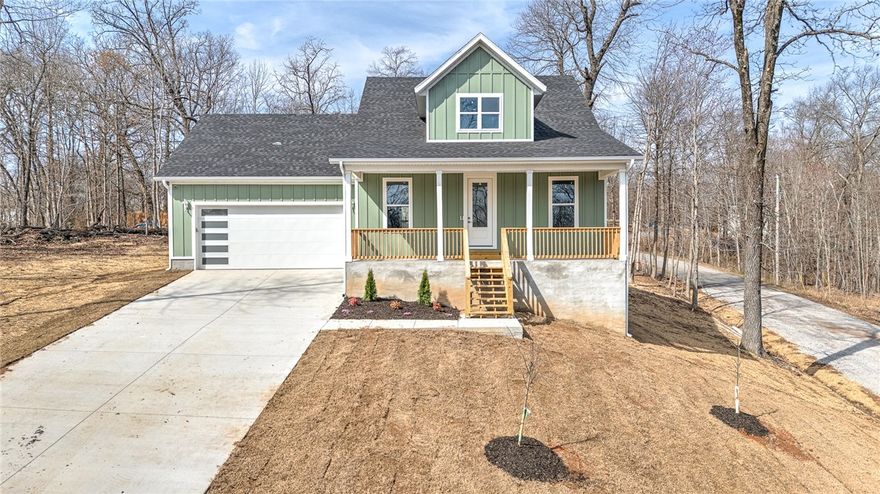Experience the best of Northwest Arkansas living in this stunning new construction home in Bella Vista. Inside, the home welcomes you with a bright and airy open-concept design that seamlessly connects the living, dining, and kitchen areas—ideal for both everyday living and entertaining. The spacious living room is the centerpiece of the home, highlighted by dramatic cathedral ceilings that create an expansive, light-filled atmosphere. The thoughtfully designed floor plan features a luxurious primary suite on the main level, offering privacy and convenience. Upstairs, additional living space provides flexibility for a media room, home office, playroom, or guest retreat—perfect for adapting to your lifestyle needs. With quality craftsmanship, contemporary finishes, and a functional layout, this home combines elegance and practicality in a beautiful Bella Vista setting. Enjoy peaceful surroundings, abundant recreation, and a vibrant community while living in a brand-new home designed for modern living.