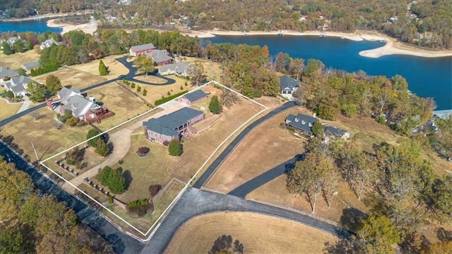 Nestled on 2.15 acres, this exquisite estate home in the highly coveted, gated, South Mountain Estates on
Beaver Lake exudes both luxury and relaxation! Whether you want to fish or swim off the private
community dock, head out on the lake; boat slip #11 conveys with home (10 ft wide x 26 ft long); relax in
the game room, or enjoy your morning coffee on the beautiful veranda overlooking the sunrise on Beaver
Lake - this home has it all! The spacious kitchen with top of the line custom finishes and a floor plan that
offers the perfect setup for indoor/outdoor entertaining of friends and family on two large verandas with
great views. Huge workshop; with garage doors on both ends. Whole home generator that conveys. All
paved roads and less than 20 minutes to town. Perfect rare combo of lake living with convenient
shopping/restaurants close by! Four newer HVAC Units less than 2.5 yrs. old; roof less than 2 years old.
Amenities list attached! View a special tour of this home here: https://vimeo.com/1100707636