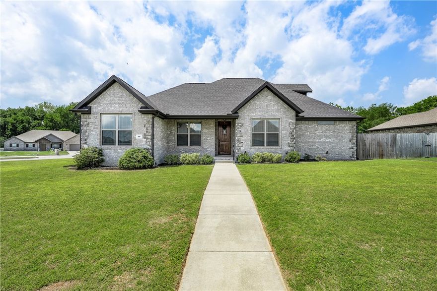 Welcome to this beautifully maintained one-owner home offering 2,460 sq. ft. of heated living space and a flexible floor plan perfect for all families of all sizes.  Located on a desirable corner lot, this home combines comfort, style and functionality. The main level features a spacious living room, eat-in kitchen with bar, formal dining, 4 bedrooms and 2 full baths. Upstairs you will find the 5th bedroom or bonus room complete with its own full bath- ideal for a guest suite. Amenities include: wood flooring in kitchen, living room, hall, formal dining, 4th bedroom/office, tile in all wet areas, trey ceilings in primary bedroom, primary bath has double sink, whirlpool tub, tiled walk-in shower and large walk-in closet, kitchen has granite countertops, stainless appliances, pantry, eat -in kitchen with bar, formal dining, covered back patio and front porch, corner lot with 3 car side load garage. Great location, close to schools, a water park and shopping, this home truly has it all.