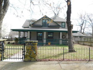 Charming 3 or 4 BR, 2 1/2 BA Vintage Home with wrap around porch, attached 2 car garage and iron and stone fence on corner lot with additional storage shed. Many updates and improvements over last several years. Soaring entry with gorgeous staircase, spacious living room with beautiful stone fireplace, very nice kitchen, relaxing den, and lots of storage. This is a Must See for anyone that enjoys the intrigue of a vintage home!