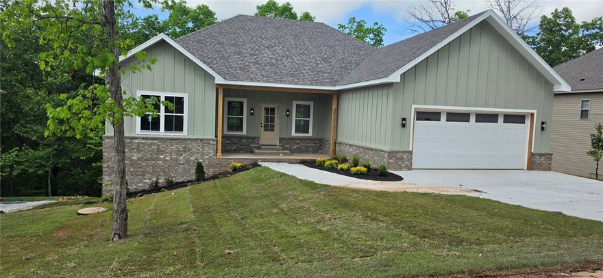Brand-new construction in a quiet Bella Vista setting with modern finishes, clean lines, and a functional open layout. Light-filled living area, quality materials, covered front porch, and a level driveway leading to a two-car garage. Fresh sod and simple landscaping create a move-in-ready exterior. Located just 0.6 miles from nearby trail access via Hampstead Rd, offering quick entry to Bella Vista’s world-class biking and walking network. Enjoy wooded surroundings, nearby lakes, golf, and full POA amenities.