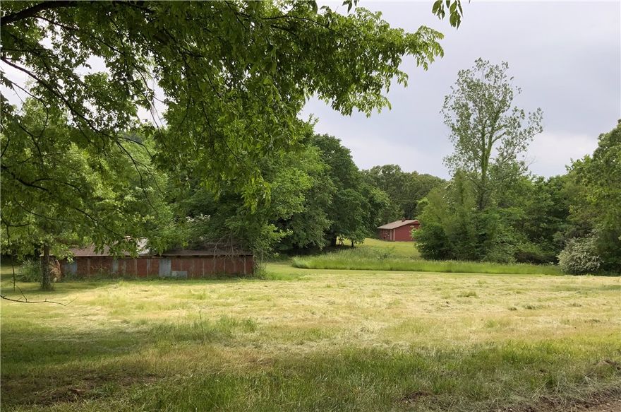 Build your dream home or multiple homes and settle into peaceful, country life! The Gayer Family Homestead, has been owned by the Gayer Family for over 100 years. Located in the community of Goshen,  just 7 miles from Fayetteville, nearby activities include the Goshen Farmers Market, Equine facilities,  or seasonal white bass fishing at the iconic Twin Bridges where the White River converges with Richland Creek. The natural beauty of this property provides a perfect backdrop for outdoor adventures and family gatherings. This parcel includes 41.53 Acres with 2 ponds, plenty of pasture for horses or farming, and riding/hiking trails. A 1,078 sq/ft., 2 BR/1BA cabin was built in 1988. It is all electric and has a woodstove-compatible  for use as secondary or primary heat source. Septic and City Water on the property. Sellers own Adjacent 5.65 property is also for sale, 20053 Pug Gayer MLS#1296860 and will consider offers on both together.