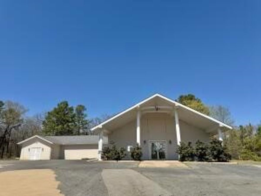 Unlock the potential of this versatile commercial building, ideally located just outside the city limits. Situated on 2.42 acres, this property offers endless opportunities for your business or investment plans. This former church building has a new roof (2024) and is currently vacant and ready for immediate use. There are many permitted uses...whether you're looking to convert it into a place of worship, a community center, office space, or even an event venue, the possibilities are vast. The building's spacious layout, high ceilings, and open floor plan provide the perfect canvas for your vision.