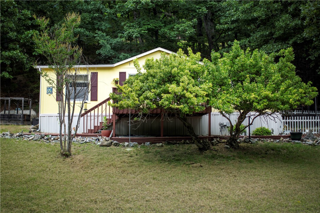 Welcome to 11747 Hickory Drive, nestled on the shores of Beaver Lake in the Lost Bridge Village Community! This 3-bedroom, 2-bath manufactured home provides comfortable living with an extra attached lot, totaling a spacious .34 acres. Being in this area, you can enjoy the fantastic amenities Lost Bridge Village offers. This includes a community pool, a fitness gym, the village lodge and library, and newly built pickleball courts. Located only 8 minutes from the Lost Bridge Marina, this property is ideal for those that want to be near the lake and have easy access to outdoor recreational activities.