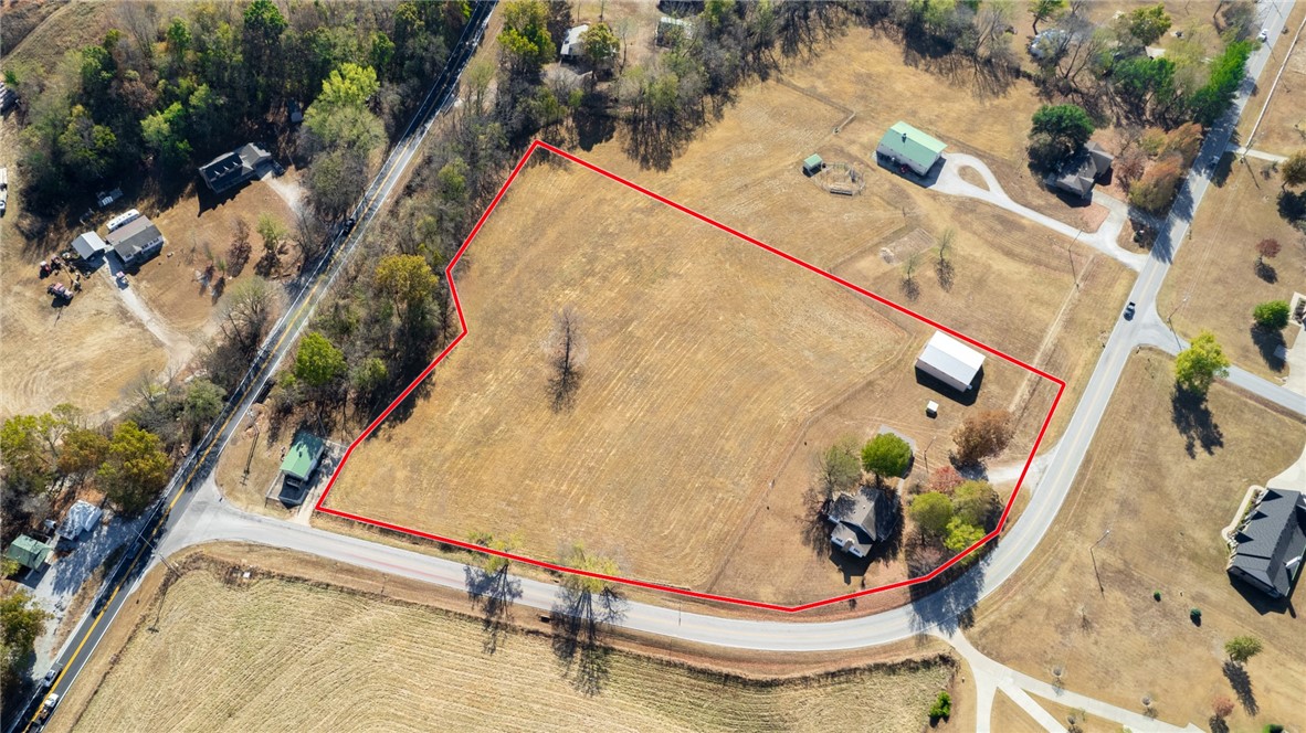 5 Acres of Prime Real Estate in Central Northwest Arkansas location! This property features a gorgeous 5.1 Acre parcel with a 2,221 SF home, detached 2 car garage & workshop, and a 2,000 SF insulated shop. Zoned agricultural this property has endless options for any buyer, whether you are looking to develop, hold investment property, or build your dream home on acreage, this site is ready for you! With public gas, sewer, water, and electric on site. The home was built in 1920s and has been very well maintained, featuring a spacious open living area, 2 bedrooms and one bath on main level and an additional 2 bedrooms and one bath on upper level. A cellar and well house add to the homestead charm. Conveniently located off Hwy 112, you have prime access to both North & South NWA. Future improvements include a roundabout at Barrington and 112 along with planned widening of 112. Don’t miss out on this amazing opportunity!