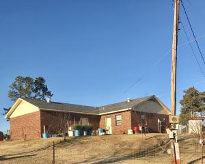 This 3 bed, 2 bath brick house with a two car garage, a nice size kitchen, and laundry room is ready for you! Other features of the property include a circle drive, pastures, a concrete outside building, barn and pasture. Good for horses or cattle! Adjoining land with a pond can be bought at a separate price.