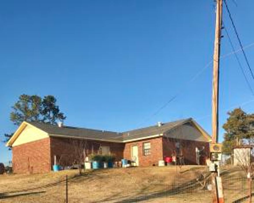This 3 bed, 2 bath brick house with a two car garage, a nice size kitchen, and laundry room is ready for you! Other features of the property include a circle drive, pastures, a concrete outside building, barn and pasture. Good for horses or cattle! Adjoining land with a pond can be bought at a separate price.