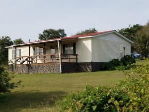 Don't pass up this clean and affordable fully equipped home. You will be able to enjoy and relax with the large 2.06 acre open and lush yard with a wooden deck and porch swing. With walk-in closets, double vanities, a storm cellar, split floor plan, large living room, and screened-in patio, you will feel right at home. Outside, this property features a shed, a shop and a utility building. All appliances convey, so this inviting home is move-in-ready. Call today for your personal tour of this must-see property!