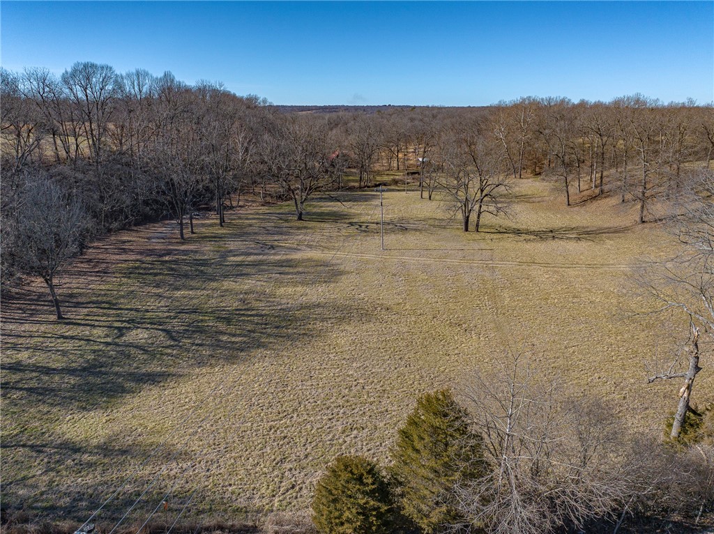 First time on the market in nearly a century. Perfect for estate homes or hobby farm with multiple building sites. Development potential with road frontage on 3 sides. Formerly used as a horse and cattle farm, fully fenced with established Bermuda grass. An old home site once stood near the spring house – the only structure left on the property for sale. Live water branches begin from the onsite spring that flows into Clear Creek and eventually the Illinois River. House and barns are excluded from the sale. Seller will consider division. Survey to determine exact acreage. Subject to lot line adjustment. City of Fayetteville water and Ozarks Electric at the street. Appointment only.