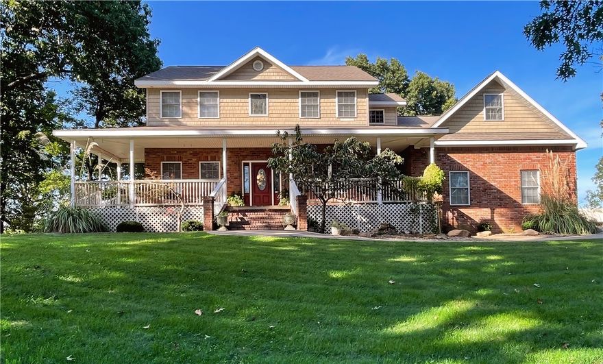 Upscale living on the outskirts of Bentonville! This stunning home sits atop the hill at the end of a private cul-de-sac with unmatched views of pastures & mountains. Enjoy a wrap-around front porch for relaxing w/your morning coffee. Enter to the main level which offers a spacious living room, dining room, breakfast area, kitchen w/granite counters, half bath, plus a charming sunroom w/access to the back deck for entertaining! Master suite includes a dedicated office, & two walk-in closets. Master bath boasts double sinks, a corner garden tub, & separate shower. Two additional guest rooms w/walk-in closets & access to a large bonus room, ideal as a 4th bedroom or playroom. Nearly 1.5 acres w/mature hardwoods, manicured grounds, & a 3-car garage. The 1,288 SF poured-concrete basement w/studs in place, offers space for finishing or use as a workshop, storm shelter, or gym. Huge walk-in pantry, dual 50-gallon water heaters, & two heat pumps ensure comfort and convenience. Beautifully maintained, & perfectly located!