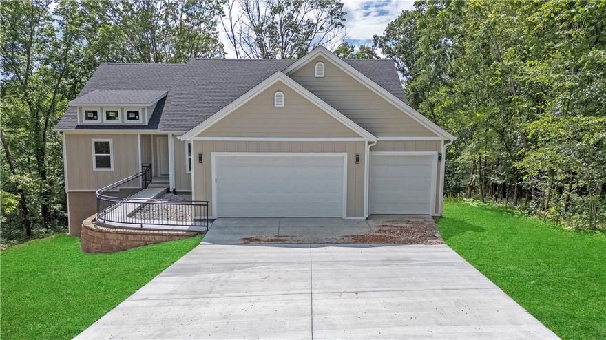 Welcome to your brand-new dream home, perfectly positioned at the end of a quiet cul-de-sac surrounded by trees on three sides for ultimate privacy and tranquility. This stunning new construction, completed in 2025, offers a seamless blend of modern finishes, spacious living, and a peaceful natural setting — all within Bella Vista’s highly desirable community. Step inside to find an open and split floor plan designed for both comfort and functionality. The living room features a cozy fireplace with gas logs and a gas starter, ideal for relaxing evenings at home. A dedicated office with elegant French doors provides the perfect space for remote work or quiet reading. The gourmet kitchen is a true highlight — complete with quartz countertops, stainless steel appliances, and a large pantry for ample storage. From the kitchen and living areas, step out onto the private back deck, where you can enjoy serene views among the trees. An exceptional home that combines modern craftsmanship with a peaceful, natural setting.