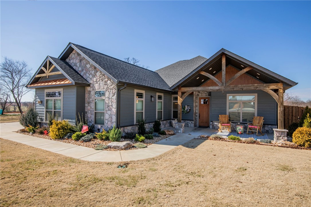 Discover the epitome of modern mountain elegance in this crafted custom home. Dive into serenity with your private saltwater pool and hot tub. Embrace the outdoors with covered front and back patios with fireplace, outdoor kitchen, and detached workshop. Home is professionally landscaped front and back with full irrigation system. Gourmet kitchen with a massive island, gas cooktop with pot filler, and lots of custom cabinetry. Oversized pantry with reinforced walls and ceiling, doubling as a safe room. Retreat to the primary suite with a walk-thru shower, soaking tub, and massive primary closet with a built-in dresser. The open living area features a soaring cathedral ceiling with wood beams, custom light fixtures, and a stone fireplace. Mudroom entry off the garage, features a drop zone, oversized sink, and space for an extra refrigerator.All bedrooms have adjoining full bathrooms. Home is located near Bentonville West High School, Centerton Gamble Elementary, and has convenient access to I-49.