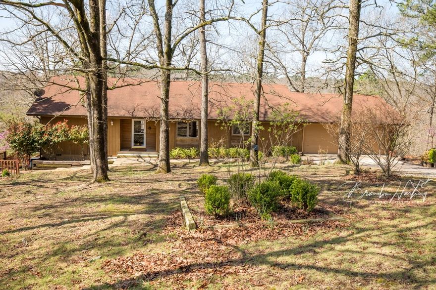 Lakefront/Lakeview on BEAVER LAKE! Approx. 169 feet of Lakefront.  Home offers 3BR/3BA/oversized 2-car gar. w/ mini workshop area (26x24), decks galore (main deck 12x26), 12x16 screened in porch off main level BR, wood burning rock FP sits on 5 lots totaling approx 1.95 acres (3 lots w/ Beaver Lake frontage) in cove, Peachtree Doors/crank out windows, John Dye built, approx. 7 miles from downtown Rogers, before Hwy 12 bridge.  HW is offered w/ home purchase.  Slip available in Community dock for $30K.