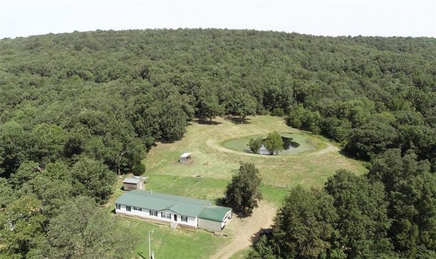 83.23 acres with gorgeous views. Property has a nice 4 bedroom 2 bath manufactured home presently on the property as well as a 24x150 shop/man cave. The property has 2 ponds, wet weather creeks and water falls. There are some trails that run through the property, as well as abundant wildlife.