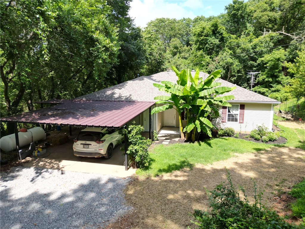 Welcome to this peaceful 3-bedroom, 2-bathroom home featuring a desirable split floor plan that offers comfort and privacy for the whole family. Set on a secluded, beautifully landscaped property, this home offers a rare blend of natural beauty and functional living. Step into the backyard and enjoy the serene view and sound of a creek with a cascading waterfall just down the hillāan ideal setting for morning coffee or evening relaxation. The outdoor space is a true retreat, surrounded by lush greenery and thoughtfully designed landscaping that enhances the natural setting. Practical features include a spacious 2-car garage with built-in storage for tools, a 30-amp outlet for equipment use, a 2-car carport, and an additional shedāproviding ample storage for all your needs. Whether you're looking for peaceful country living or a well-equipped home close to town, this property offers the best of both worlds.