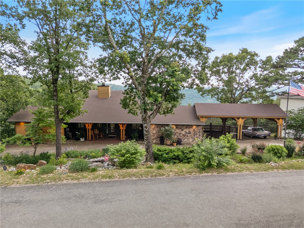 Welcome to luxury! Nestled on nearly an acre across two prime lots, this stunning custom home at 7 Eldorado Dr is more than a houseāitās an experience. From stone walls and a custom covered carport to panoramic views, this home radiates charm. Inside, enjoy exposed beam ceilings, gas fireplace, and a warm modern, ranch style feel. Multilevel design provides ample space for everyone, this home adds unique character, while thoughtful upgrades shine throughout. Relax year-round in the four-season glass room with your own master swim spa. Whole-house Generac generator, vaulted light-filled spaces, upgraded kitchen with Spanish granite and high-end stainless steel appliances. Step outside to 2 decks which provide stunning views and room for entertaining! This home has tons of upgrades to the entire home. So if you are ready to be Surrounded by nature in a vibrant community where golf, boating, and relaxation are at your fingertips look no further, this rare Holiday Island gem is ready for you to call home!