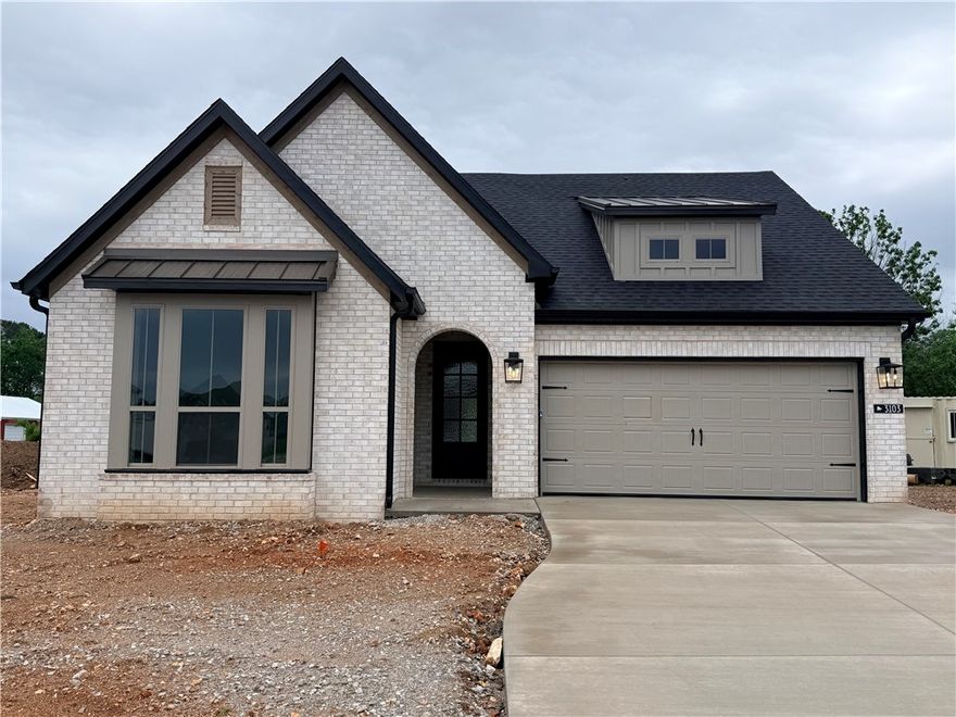 Experience elevated living in the desirable Blossom Woods community! This Sutton floor plan offers open-concept living with a vaulted living room, striking beam detail, and cozy indoor gas fireplace. The designer kitchen features ceiling-height cabinetry and a single oven with a gas cooktop layout. Retreat to the spa-inspired primary suite with a freestanding oval soaker tub for ultimate relaxation. Enjoy seamless indoor-outdoor living with an enlarged covered patio and an outdoor vent-free gas fireplace—perfect for year-round gatherings. Ideally located near shopping and dining off Pleasant Grove, less than 5 miles to downtown Rogers and Lake Atalanta, and just minutes from Topgolf and Walmart AMP. Enjoy nearby walking trails and nature preservation, perfect for an active, outdoor lifestyle! Easy access to I-49 and just south of Walmart Headquarters!