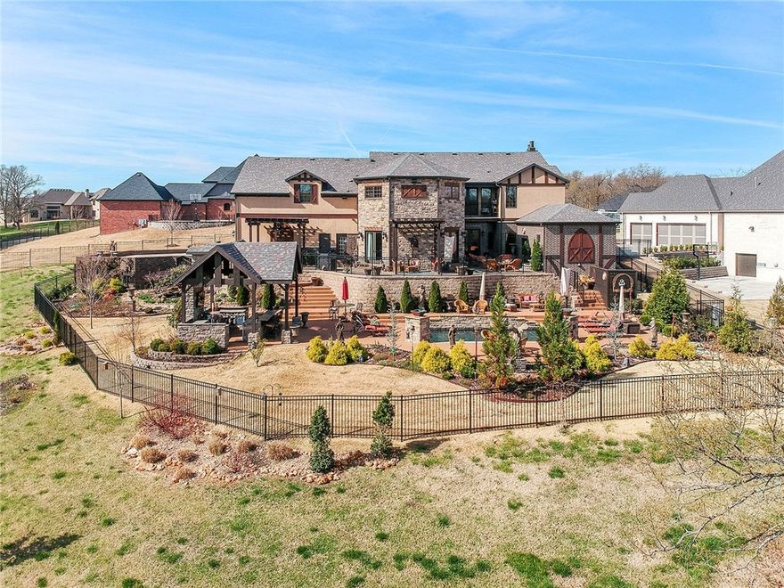 Elegant, custom Tudor home marries old world charm with modern amenities! Breathtaking 22' ceiling in kitchen, breakfast and family room. 6x9 island with copper apron sink and copper prep sink, 2 dish washers, china storage, 6 burner stove with griddle make kitchen perfect for entertaining! Generous outdoor seating overlooking salt water pool with copper waterfalls. Outdoor kitchen on patio by pool. There's even an outdoor shower! Juliette balcony in upstairs bedroom overlooks kitchen/family room. Each bedroom has a private bath. Attic over 3 car garage has shelving, workbench & plumbed for water & sewer. To be featured on upcoming HGTV episode. A Must See!