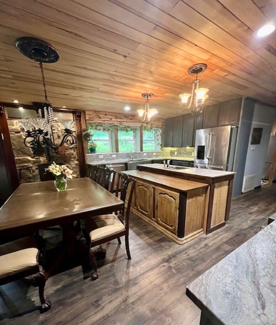 The perfect NW Ar. serene nature retreat can be your home away from home nestled in the woods. Sitting on 2.98 Acres, the home is surrounded by beautiful flowers & natural beauty. The home’s stunning kitchen & bath, were recently remodeled. Equipped with a Verona 6 burner gas range w double oven, full size refrig, plus a beverage refrig, a drawer microwave built in the island. The surfaces are lined with granite, tile and wood creating the perfect kitchen w buffet for the adjacent fireside dining area. With 3 fireplaces, a wood stove, native stone hearth, central hvac, 3 split units & a generator, you are set for comfort all year long. Master BR/Bath enjoy a huge walk in shower, double vanity sink. Utility room, office nook and walk in pantry also. The spacious lower level sunroom with fireplace has a shelf lined wall & opens to the back deck outdoor cooking/entertainment. 3 storage buildings function as you like, along with a 2 car carport and shed.