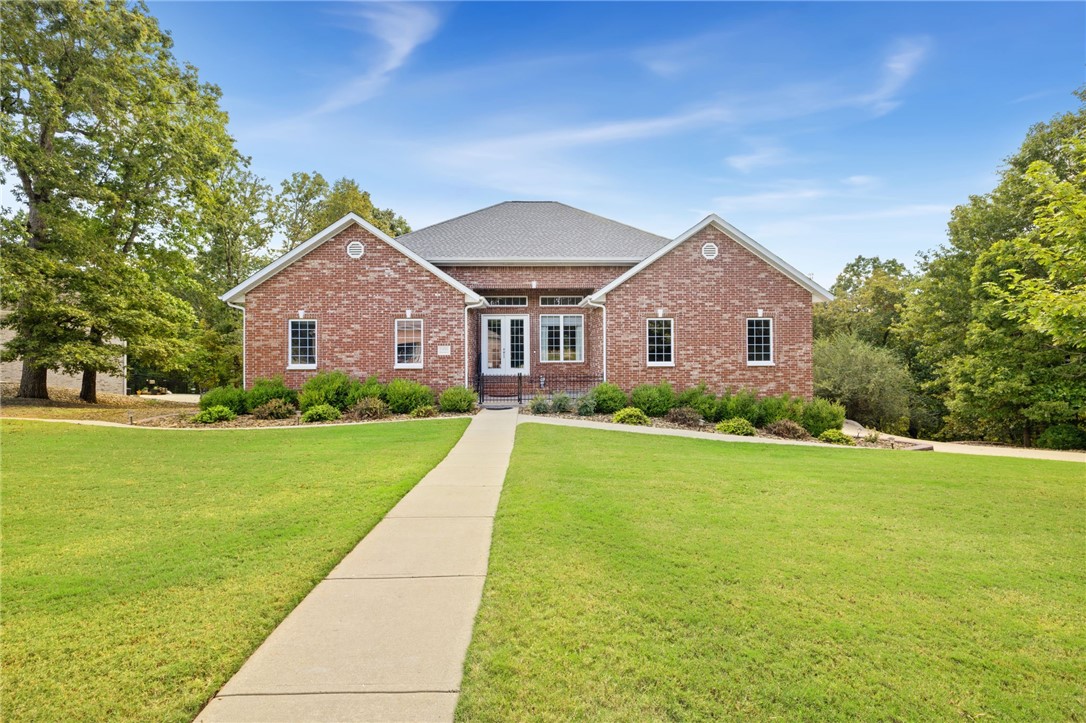 BOAT SLIP SOLD SEPARATELY. Discover this spacious 4,277 sq ft home in The Preserve subdivision, perfectly situated near Beaver Lake yet just minutes from downtown Rogers. Nestled on a private, wooded 1.30-acre lot, this all-brick home offers 4 bedrooms, 3 full baths, multiple living areas & exceptional storage throughout. Inside, youāll find hardwood floors, custom cabinetry, crown molding & large walk-in closets. The open kitchen features quartz countertops, large island and ss appliances, flowing seamlessly into a hearth room w/gas log fireplace & built-ins. The main-level primary suite boasts his/hers closets, deck access & a spa-like bath w/dual vanities, jetted tub, & walk-in shower. The walk-out lower level includes a large living area, wet bar, full bath, oversized bedroom, flex space w/safe, & access to a covered patio. Outdoor living is enhanced with both upper & lower-level spaces to enjoy the natural setting. Additional features include two laundry rooms, 4-car garage (2 up/2 down), and new roof (2025).