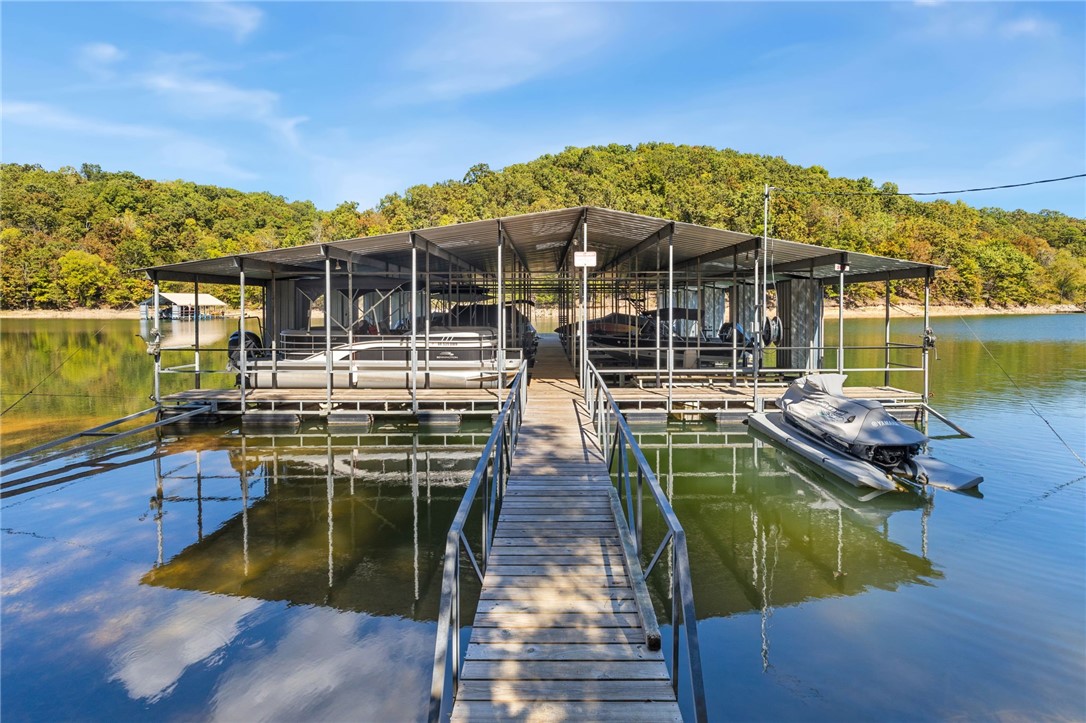 BOAT SLIP SOLD SEPARATELY. Discover this spacious 4,277 sq ft home in The Preserve subdivision, perfectly situated near Beaver Lake yet just minutes from downtown Rogers. Nestled on a private, wooded 1.30-acre lot, this all-brick home offers 4 bedrooms, 3 full baths, multiple living areas and exceptional storage throughout. Inside, youāll find hardwood floors, custom cabinetry, crown molding & large walk-in closets. The open kitchen features quartz countertops, large island and ss appliances, flowing seamlessly into a hearth room with gas log fireplace and built-ins. The main-level primary suite boasts his/hers closets, deck access and a spa-like bath with dual vanities, jetted tub, and walk-in shower. The walk-out lower level includes a large living area, wet bar, full bath, oversized bedroom, flex space with safe, and access to a covered patio. Outdoor living is enhanced with both upper and lower-level spaces to enjoy the natural setting. Additional features include 4-car garage (2 up/2 down) and new roof (2025).