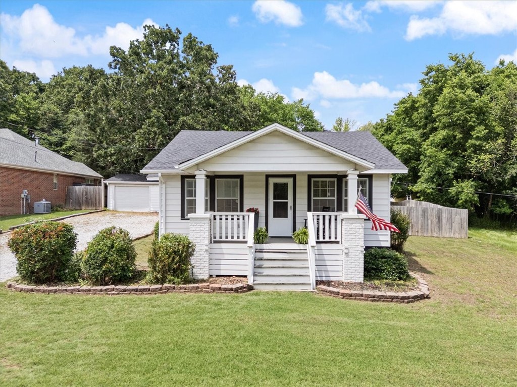 Location, character and charm sum up this 2 bedroom, 1 bathroom home located 1 mile from Gulley Park and 8 minutes from the Fayetteville Square. As the original 1933 farmhouse, this property sits on 0.31 acres in the coveted Root Elementary school zone. This home features beautiful natural light with 17 windows, cellular shades and gorgeous original wood flooring. Entertain a crowd and watch the hogs play on the covered patio. Use the large yard and the two wells on the property, to start a garden for your next homestead. Enjoy your coffee on the front porch and listen for the bells from Old Main. Great spot for a family, college students, or a 2nd home for UA patrons. Come see this cozy home today!