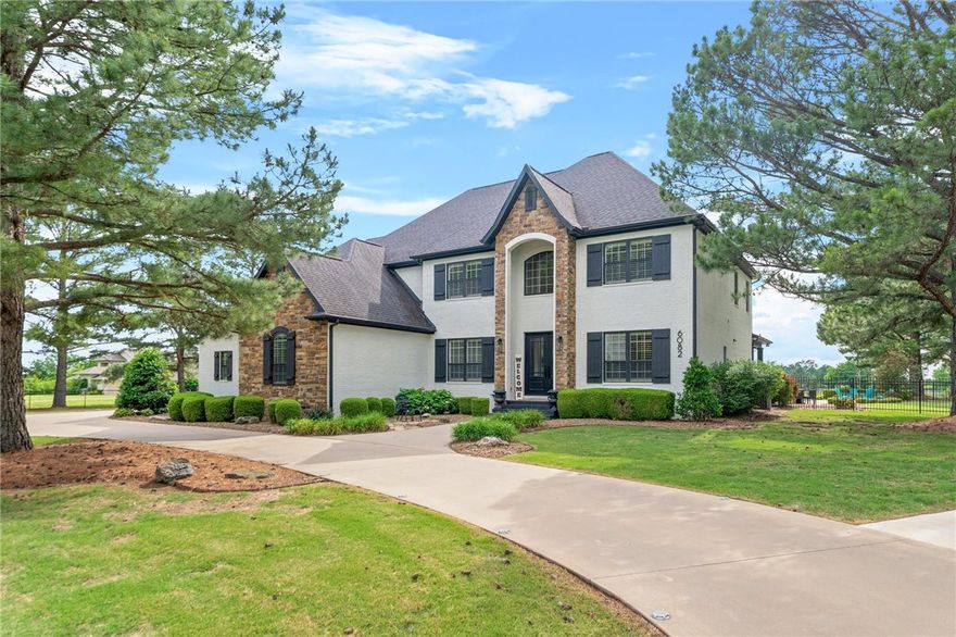 Discover refined living in this meticulously crafted 5,651 sq. ft. colonial-style estate, nestled on 1.57 private acres in the prestigious Pack Lane neighborhood of Rogers. Built in 2010, this stately home blends timeless architectural elegance with modern comfort, offering an exceptional lifestyle for discerning buyers. The main residence features five spacious bedrooms, elegant formal and casual living areas, and high-end finishes throughout.  Step outside to your private backyard oasis, complete with a heated saltwater pool, covered patio, and a charming gazebo with a fireplace. Additional features include a detached 1,200 sq. ft. shop, currently leased at $2,500/month—offering income potential or versatile utility space. This is more than a home—it’s an estate crafted for those who value elegance, privacy, and comfort.