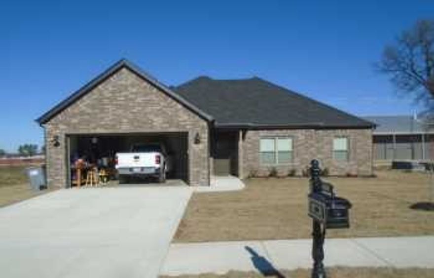 This beautifully designed 4-bedroom, 2-bath home offers an inviting blend of comfort and modern style, highlighted by raised ceilings that create a spacious, airy feel throughout the main living areas. The kitchen serves as the heart of the home, featuring sleek granite countertops, custom cabinetry with ample storage, and a full suite of stainless steel appliances that combine both function and sophistication. Rich wood flooring flows seamlessly through the living spaces, adding warmth and durability, while the bathrooms are thoughtfully appointed with elegant finishes, including a double vanity that provides convenience and plenty of room for daily routines. The primary suite stands out with a luxurious walk-in shower, offering a private retreat designed for relaxation. Every detail of this home has been carefully considered to deliver both style and practicality in a layout ideal for everyday living and entertaining.