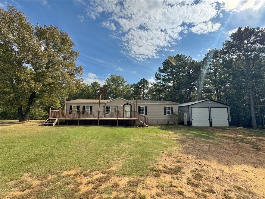 At the end of a quiet dead-end road in the Dardanelle School District, this home sits on a full acre of flat, usable land with room to breathe. A major bonus is the large metal shop, just under 900 sq ft. with rolling bay doors, ideal for storage, hobbies, or home business needs. The home offers an open concept layout with split bedrooms and space to update to your taste, and the yard has plenty of room for pets, play, or parking. Minutes to in-town conveniences yet tucked out of traffic, this spot hits the sweet spot for privacy and practicality. Sellers are very motivated and offering a $10,000 allowance for your buyer to apply toward closing costs or upgrades; instant equity opportunity for someone ready to make it theirs. A rare combination of acreage, shop space, and end of road setting at an attainable price point in the River Valley.
