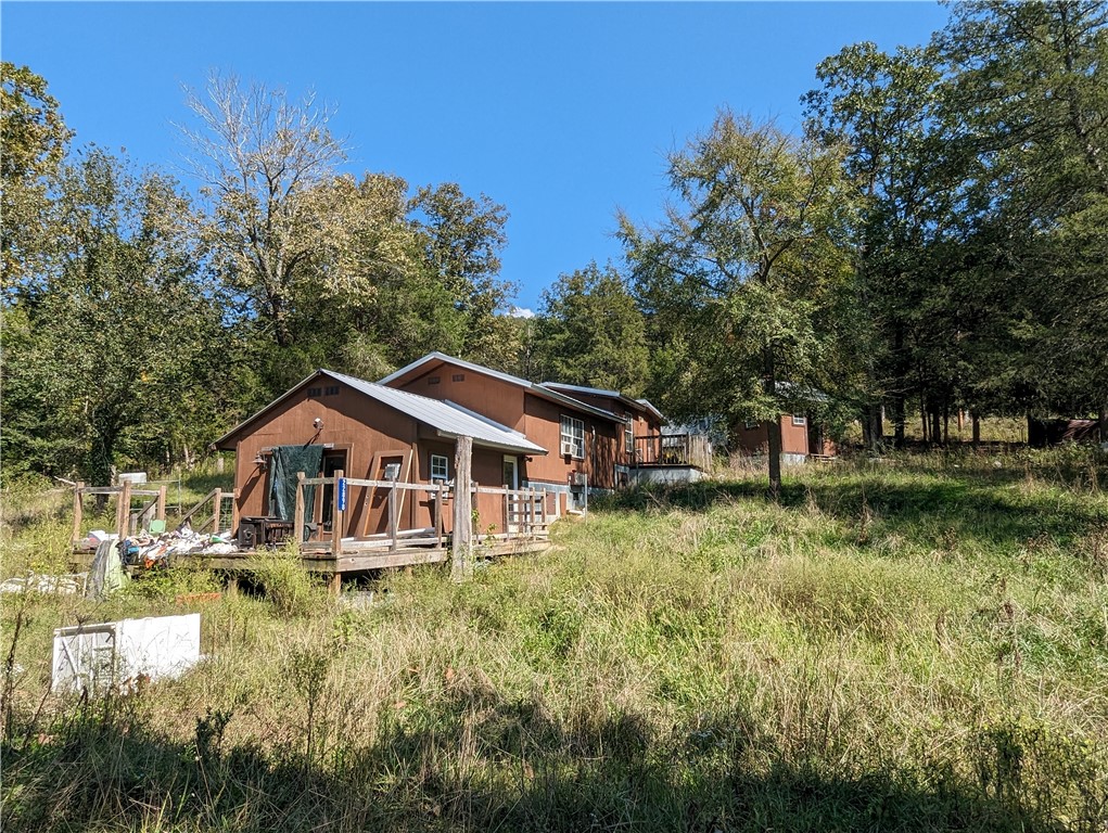 Opportunity Awaits. 25+/- Acres Plus Home That Needs Lots Of TLC But Just Waiting For Someone To Bring It Back To Life. Beaver Lake Area, Secluded, Trees, Seasonal Creek Across The Road...So Much To Love Here. Fix Up The Current Home, Build Another, Or Both. Great Potential. Come See! (check previous listings to see what the home looked like prior and the potential it has)