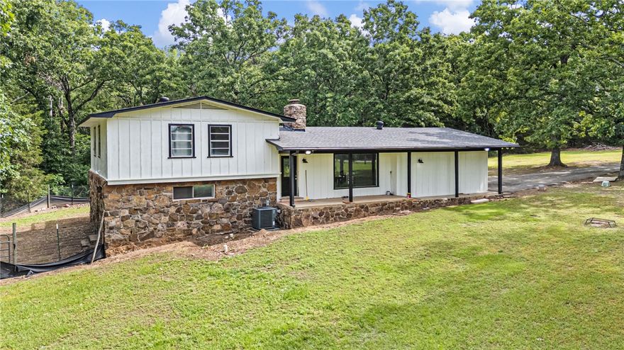 Completely remodeled and move in ready, this 4 bedroom, 3 bath home sits on 4.31 acres offering a mix of cleared yard space and wooded privacy. Two primary suites, one upstairs and one downstairs, provide flexibility for multigenerational living or guests.

Updates include new plumbing, HVAC, electrical panel, flooring, and fully renovated bathrooms taken to the studs. Roof is approx. 8 years old.

The garage was converted into additional living space, adding versatility. All appliances convey. Updated ceiling fans throughout and hardwired smoke detectors tied into the electrical system add safety.

Outside features include a large deck overlooking the acreage, full outdoor lighting, vapor barrier in crawl space, and a security camera system.

This property offers acreage, privacy, and modern updates in one package. Additional highlights include open layout, natural light, and peaceful setting close to town. A rare combination of updates, land, and convenience in one property!