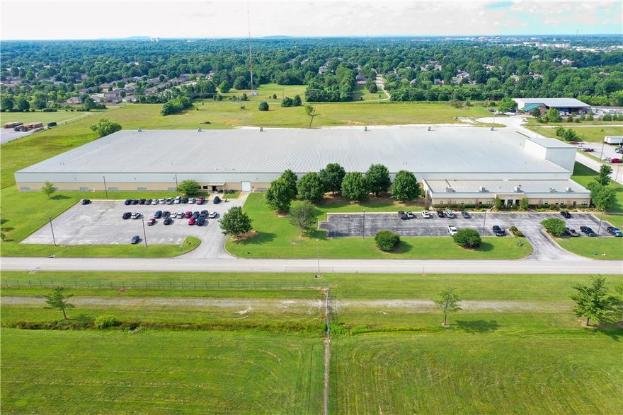 Warehouse/Industrial space located with easy access to I-49 (94,000 VPD).  ±11,000 SF of professional office space.  One roll up, drive in door and 22 loading docks.  Up to 24' ceiling height.  Entire warehouse is sprinkled.  1.6 miles from the new Walmart corporate campus.