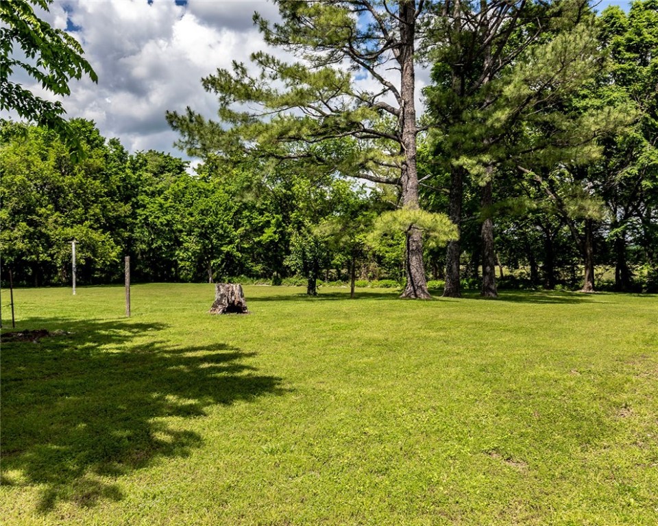 Opportunity knocks! Homestead of 7.385 acres (per current survey) with utilities already on site. Ground is level, has established pastures of lush grass, groves of mature trees for shade, several garden area prospects, and a creek (Fly Creek). Improvements include a 30x16 pole shed and two additional outbuildings. Utilities in place include electricity, public water and an owned propane tank. Additionally, there are two unused wells on site (currently not equipped or in service). NO RESTRICTIONS. **An old house remains and conveys as-is with the land. There is no entry to the house permitted at this time.**
