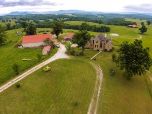 OZARK MOUNTAIN RANCH 1,790 Acres!! Beautiful home, Great views all over. 500+ acres of pastures, 1,200+ acres woodland, Large Barns, Year Round Creeks, 8 year round Springs, 15 ponds, several WATERFALLS, caves, wonderful hunting and wildlife, 20+ food plots and it's own meat processing locker. Owner states spotted 17 bears spotted in past year on the place. Miles and miles of roads.(See Supplement