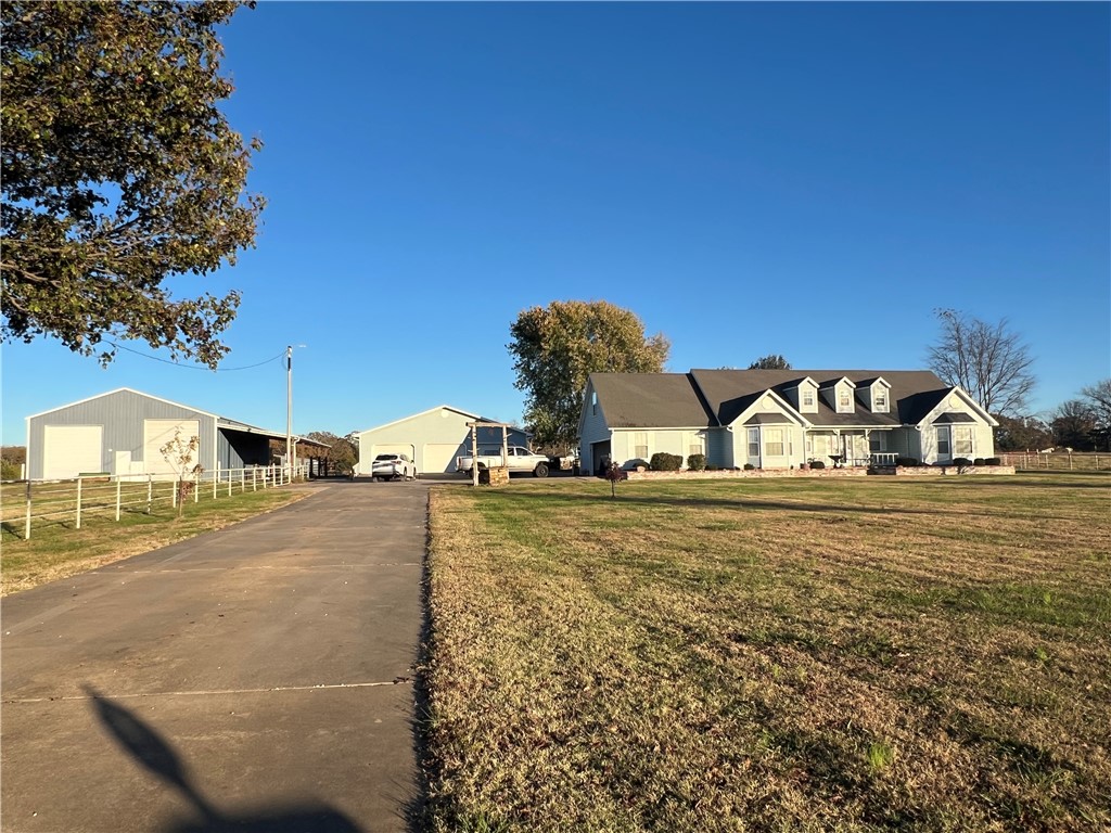 Price reduced!! Beautiful home on approximately 17.65 acres. 2 living areas, wet bar, fireplace, lots of kitchen cabinets, granite. French doors to covered patio. 2-car attached garage plus 3-car detached with shop area. New 70x30 hay barn, fenced. Separate electric and water hookups behind pasture.