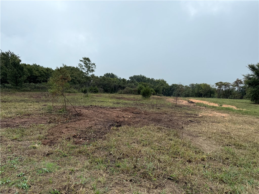 Hard to find 5+ acres cleared and ready for new owner. Hwy frontage, electric pole and water tap approved awaiting installation. This property is centrally located with close proximity to NW Arkansas and Eastern Oklahoma.