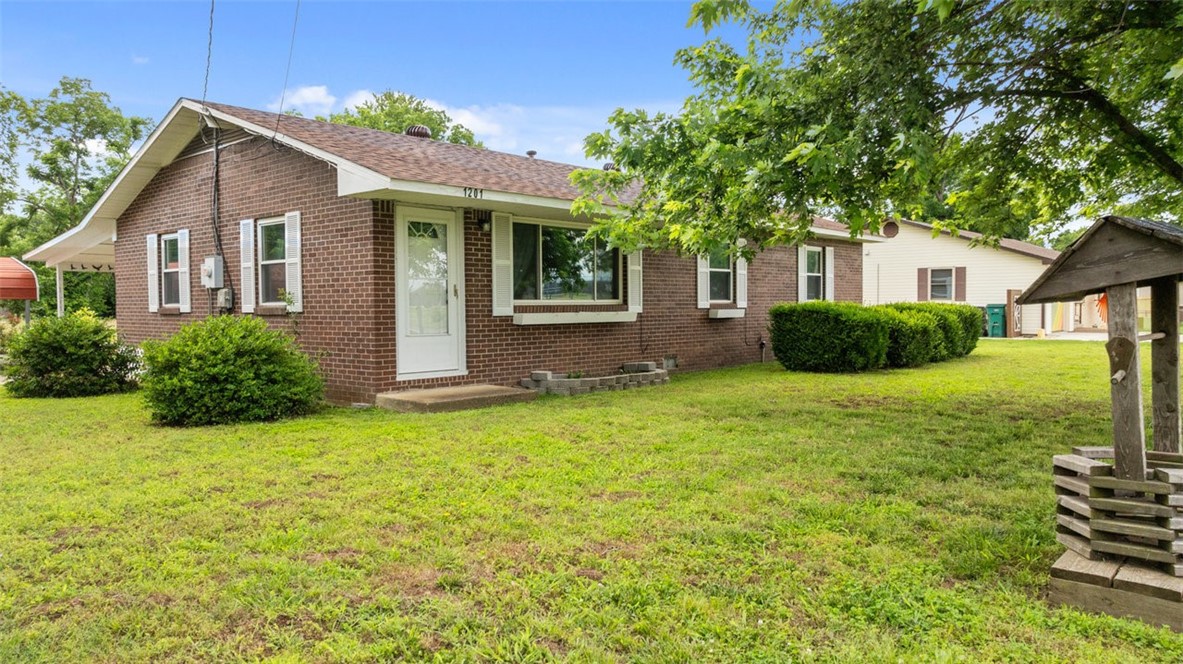 Welcome to 1201 S. 5th Street! This one owner home sits on a nice flat lot & is located directly across the street from the Rogers Heritage High School, making it a prime location to be close to everything Rogers has to offer. Downtown Rogers is less than a mile away, which is great for a date night or hanging out w/the kids. The exterior of the home is all brick, had a new roof in 2024 & updated vinyl windows in the recent past. There are 2 covered parking spaces & a small fenced in area w/a small shed to give you a place to tinker on your lawn mowers or store any of your outdoor equipment. Inside the home offers 3 cozy bedrooms w/cedar lined walk-in closets, a good size laundry room w/a half bath, a full bath w/a shower/tub combo, cute little kitchen w/a small dining area & a good size living room to relax after a hard days work. With the home having the same owner for the last 60-ish years, you can imagine how well it has been maintained & with a little bit of freshening up inside & this house will be perfect.