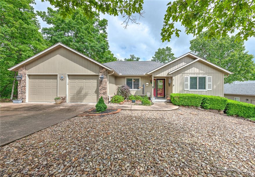 Beautiful thoughtfully updated lake area home, minutes to Loch Lomond. With its close proximity to area lakes, parks and trails, this home offers the best of Bella Vista living — combining modern convenience with outdoor adventure. The spacious primary bedroom has a completely updated bathroom with a large walk-in shower, stylish faucets & sinks, granite counters, heated/radiant floors with a programmable timer and a large walk-in closet. You're welcomed at the front door with new wood floors & barn-style accent doors. The large updated eat-in kitchen provides ample space for family meals and entertaining guests. Adjacent to the kitchen & open living room, step into the light-filled sunroom. The exterior & double covered patios has been freshly painted. Choose to relax in either of the double open decks with a serene outdoor retreat and firepit area for barbecues or simply soaking in the natural surroundings. The newly added firepit area makes for a perfect evening gathering spot under the stars.