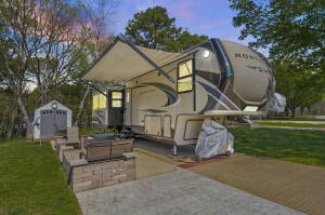 Looking for your own camping spot and never have to worry about reservations? Here is your opportunity! Deeded RV Lot setup with 2018 Montana High Country 38' RV, which has been sightly used since purchased new and pulled onto the lot. Completely furnished, including the storage shed and all the patio furniture. Turnkey ready to start your summer vacations. In the gated community of Cricket Creek RV Park this is a large lot with extended concrete area to offer more outdoor space and parking all on a level Table Rock Lake View lot. Just around the corner is Cricket Creek Marina (full-service marina), offering boat rentals, gas, food, short- and long-term slip rentals and all your fishing supplies. The Army Corp of engineer park offers swimming & picnic area.