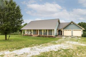 Country living with convenience! Enjoy 6 acres surrounded by pastureland with Hwy 23 frontage, directly across from Madison County Wildlife Management Area. Well finished home with 3 bedrooms plus bonus room/4th bedroom & 2.5 bathrooms. Bright, open floor plan with gorgeous hardwood floors, brick tile pavers in bathrooms, crown molding and 6 inch baseboards throughout. Kitchen features copper countertops and large island. Living room with beautiful wood burning fireplace. 2 walk-in closets, large laundry/mud room with work area and closet. Insulated and finished garage with storage and closet. Large covered front porch. Back deck with scenic pasture and pond view. 6 acres suitable for hobby farm with plenty of room to build a shop. Additional 20x40 older metal building on site for storage.