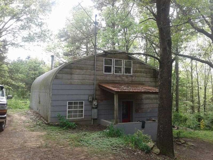 Unique Kwanza hut style home tucked away on beautiful land on Culpepper Mountain. This is one of those peaceful, quiet place3s where you can truly unplug and feel like you're miles away from everything -- yet still close enough to town when you need it. The split-level, energy-efficient home could use some updating and a little TLC, but it has great bones and tons of potential to be turned into the farmhouse-style retreat you've been dreaming about. Outside, you'll find multiple outbuildings and shops, including as 12x16 outbuilding with electric, a 30x24 shop with electric and a roll-up door, and a 30xo30 barn with 10 stalls and storage--perfect for animals, hobbies, equipment, or your next big project. The land is fenced and features a stocked pond, making it ideal for livestock, fishing, or just enjoying quiet evenings by the water. If you've been craving space, privacy and a place that feels like a true getaway, this one checks all the boxes. Square footage and building sizes are approximate; buyer to verify.