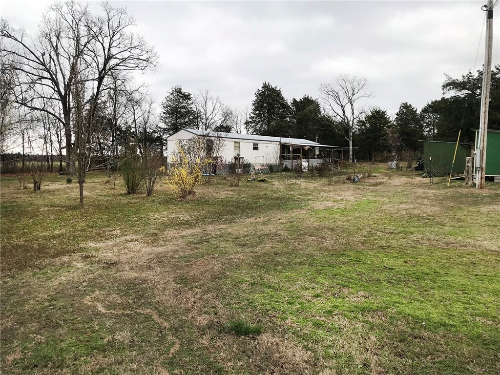If you are looking for a Quiet 3.02 +/- Acres of rural heaven, here is your chance. Gardening, fruit trees, crape myrtles, cedar, open northern view, private from road, storage buildings, chicken coop, dog pen,and ample road frontage make this a nice piece to call your own. Mobile home is still on axles with tongue and could be easily removed for a wonderful home site. Home is move in ready for a weekend getaway or rental. Most value is in the prime land. Septic System is only 6 years old