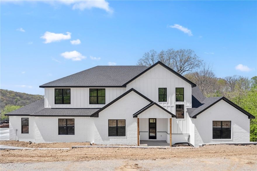 Welcome home to the beloved Eau Claire subdivision! Nestled on 1.25 acres with gorgeous valley views, this spacious 4-bedroom, 3.5-bath retreat offers 3,307 SF of thoughtfully designed living space with an upstairs bonus room—perfect for movie nights, play space, or a game room—as well as a dedicated office featuring a custom accent wall. The home boasts storage everywhere, so there’s a place for everything (and everyone). The oversized 900 SF garage includes custom epoxy flooring, ideal for projects, parking, or extra storage. At the heart of the home is a stunning chef’s kitchen with luxury finishes and a walk-in butler’s pantry—perfect for entertaining or keeping daily life organized. With 3 heating and 3 AC units, you’ll enjoy comfort in every season. Outside, take in the views from the expansive deck, offering a peaceful setting to unwind or entertain. Zoned for Bentonville Schools and just a short drive to trails, parks, and downtown, this home checks all the boxes for comfort, style, and location.